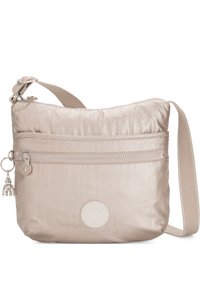 Beige crossbody bag made of smooth fabric; features a zippered front pocket, adjustable strap, and a circular logo accent.