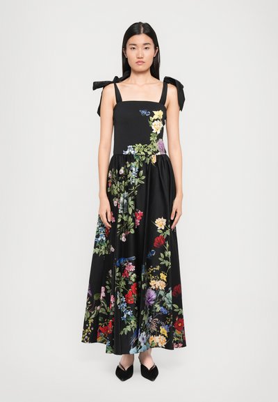 Abito maxi nero a fiori con bustino aderente, ampie spalline da legare e fiori ricamati colorati su tutta la gonna. Tessuto morbido e design fluido.