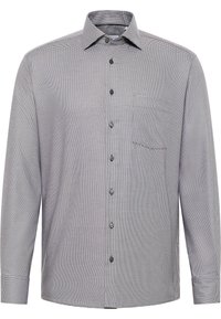 Langarmhemd im Schwarz-Weiß-Karomuster, mit umklappbarem Kragen, Brusttasche und schwarzen Knöpfen. Aus Baumwollstoff.