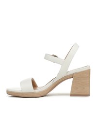 Sandali con tacco in pelle bianca, dotati di un tacco a blocco in legno, punta aperta e due cinturini regolabili alla caviglia. Texture liscia con design minimalista.