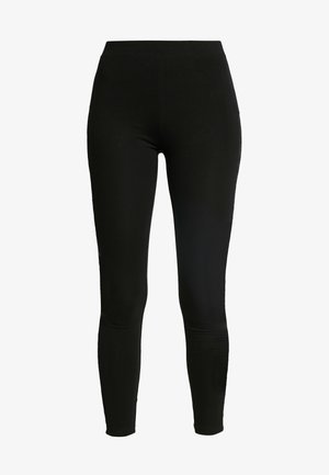 Svarte leggings laget av elastisk stoff, med høyt liv og tettsittende design som smalner inn ved anklene. Glatt tekstur uten mønstre.