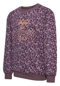 Lila sweatshirt med ett mönstrat ytskikt som har en blandning av svarta och lila prickar. Guldlogotyp och årtal "1923" på framsidan. Ribbad mudd.