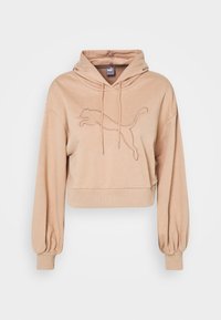 Felpa corta beige con maniche lunghe a sbuffo, cappuccio con lacci e logo Puma ricamato sul petto.