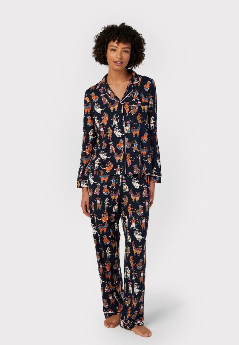 Navy pajama set featuring a patterned design of cartoon animals, with a collared shirt and long pants, made from a soft fabric.