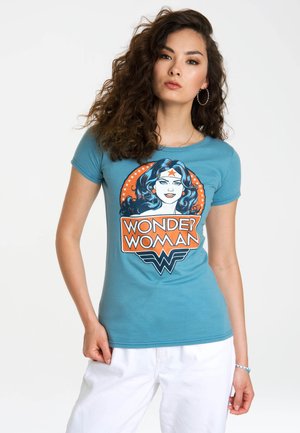 Blue cotton T-shirt featuring a printed Wonder Woman logo with a graphic design including red and orange accents. Short sleeves.
