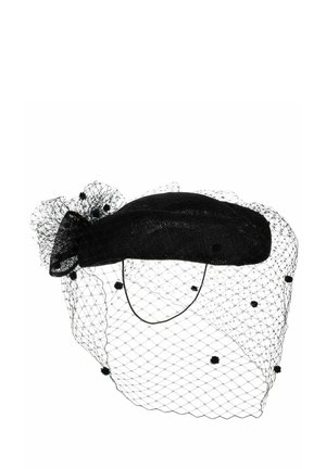 Black vintage-style hat with a netted veil decorated with small pom-poms and a bow at the back.
