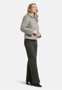 Gray wool blend jacket with a textured pattern, featuring a wide collar and two purple buttons, paired with dark gray tailored pants.