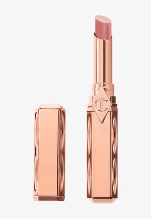 Rose gold lipstick tube with cap removed, displaying a light pink lipstick and embossed diamond-shaped logo on the case.