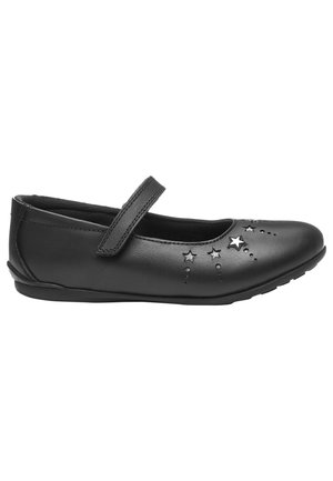 Chaussure plate Mary Jane noire avec une bride et des découpes en forme d'étoile à l'avant et sur le côté, conçue pour enfants ou usage décontracté.