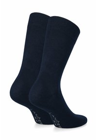 Granatowe skarpetki z prążkowanymi mankietami, gładką teksturą oraz wzmocnionymi piętą i palcami. Na dole znajduje się biały nadruk z nazwą marki.