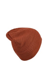 Rust-colored knitted beanie with a ribbed texture, slouchy design, and a rounded top. Made from soft, stretchy fabric.