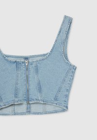 Cropped bustier in denim blu chiaro con chiusura frontale a zip, spalline larghe e cuciture strutturate per definire. Texture liscia e design aderente.
