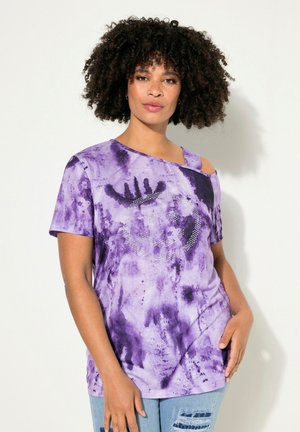 Lila Batik-T-Shirt mit kurzen Ärmeln und asymmetrischem Ausschnitt, verziert mit einem Strass-Smiley-Gesicht. Aus weichem Baumwollstoff.