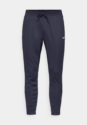 Navy blue athletic pants made of smooth fabric, featuring an elastic waistband with drawstring and a small white logo on one side.