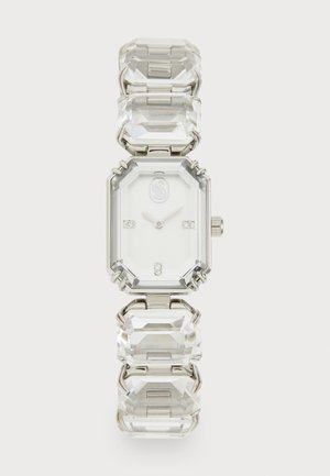 Reloj de cristal transparente con esfera octogonal, hardware plateado y eslabones rectangulares. Cuenta con una esfera blanca y cuatro pequeños acentos de diamante.