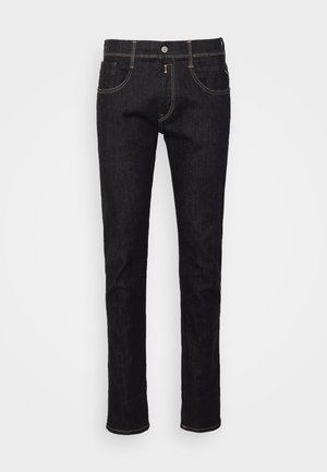 Jeans neri in denim con un fit slim, dotati di chiusura a bottone, cinque tasche e cuciture gialle a contrasto lungo le cuciture.