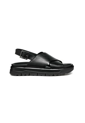 Sandali in pelle nera con design a striscia incrociata, cinturino regolabile alla caviglia e suola in gomma texture per una buona aderenza.