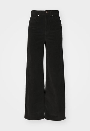 Zwarte corduroy wijde broek met een hoge taille, voorzien van twee voorkruimels en een metalen knoopsluiting. Textiel met verticale ribbels.