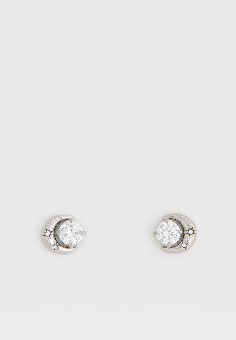 Ασημένια σκουλαρίκια σε σχήμα ημισελήνου με καθαρά στρογγυλά κρύσταλλα και μικρές ακτινωτές διακοσμήσεις αστεριού σε λευκό φόντο.
