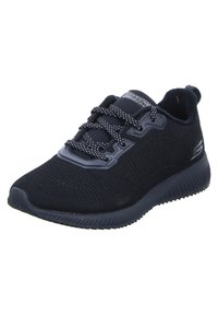 Scarpa sportiva nera con tomaia in rete e texture rigata. Presenta lacci con motivo e una soletta imbottita per il comfort. Branding sul lato.