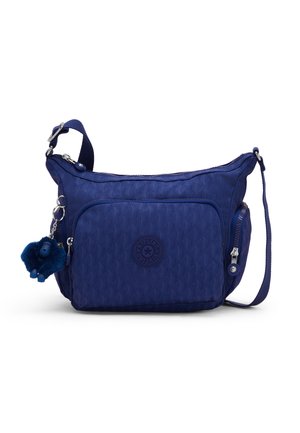 Petit sac à bandoulière bleu avec tissu texturé, poche zippée avant, poche zippée latérale, bandoulière réglable et porte-clés singe en peluche attaché.