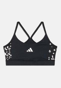 Mustmustükk musta rihmakaelusega spordirinnahoidja. Omab hõbedasi leopardimustreid ja valget Adidas'i logo ees. Sile tekstuur.