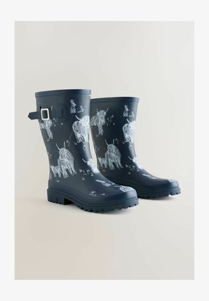 Navy rubber rain boots featuring white animal sketches, with a buckle accent, textured soles, and a smooth finish.