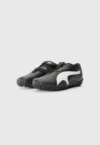 Mustad mustsade spordijalatsid tekstiilse pinnaga, valge aktsendi, Velcro rihma ja tallaga, millel on haardumisprofiil.