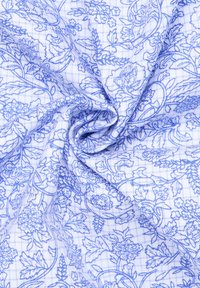 Blauw-gepatroneerde stof met een bloemmotief en een witte, grid-achtige achtergrond. De textuur lijkt glad en licht van gewicht.