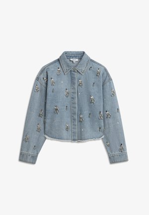 Denim jacket in light blue with a cropped design, embellished with silver rings and studs throughout, featuring a classic collar and button front.