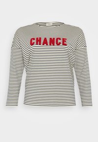 Striped long-sleeve shirt in cream and navy, featuring "CHANCE" in textured red letters across the chest. Soft fabric, relaxed fit.