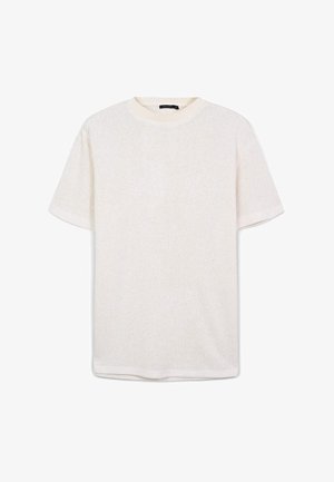 T-shirt à manches courtes en blanc, avec un tissu texturé et un col rond côtelé. Coupe droite et ajustement décontracté à l'ourlet.
