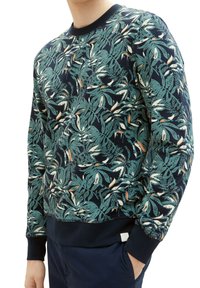 Námořnicky modrá mikina s zeleným vzorem listů, bílými akcenty, žebrovaným kulatým výstřihem a manžetami, měkkou texturou a rovnou hranou.