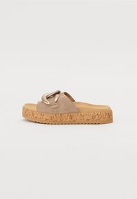 Beige suede slide sandals with a metallic chain accent, cork sole, and textured platform. Flat with an open back and rounded toe.