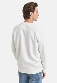 Weißes Baumwoll-Sweatshirt mit Rundhalsausschnitt, gerippten Bündchen und Saum. Es zeichnet sich durch eine glatte Textur und ein minimalistisches Design aus.