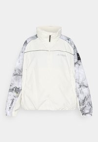Terrex lightweight jacket in off-white, featuring patterned gray sleeves, a high collar, zip closure, and elastic cuffs for comfort.