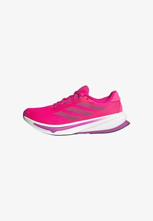 Pink running shoes with a mesh upper, a white midsole, and purple accents. Three gray stripes on the side and a curved sole design.