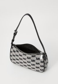 Gray and black canvas handbag featuring an all-over MK logo pattern, zip closure, and a slim shoulder strap.