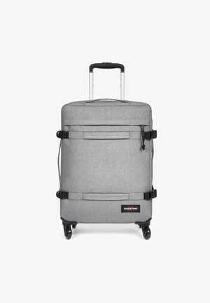 Valigia grigia con ruote, finitura testurizzata, manico estensibile, tasca frontale con zip e cinghie regolabili. Presenta quattro ruote per una facile mobilità.