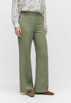 Wide-leg trousers in light olive green fabric, featuring a smooth texture and side pockets, paired with a floral patterned blouse.
