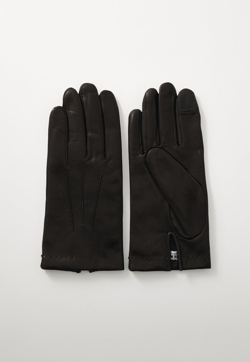 Gants en cuir noir présentant une texture lisse, cinq doigts, des coutures visibles, et un ajustement serré au poignet avec une petite étiquette de marque à l'intérieur.