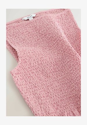 Rožinė rankovių neturinti palaidinė iš tekstūruotos medžiagos, su susegta detale ir subtiliu banguotu efektu, pažymėta etikete „NEXT“.