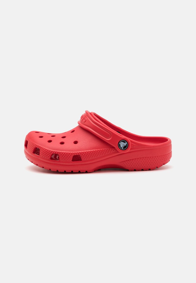 Red rubber clog with ventilation holes, raised edges, a strap across the top, and a textured sole for grip.