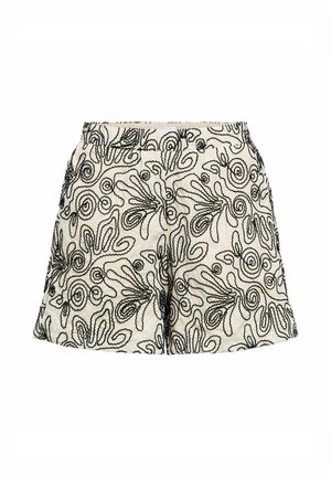 Shorts blancs avec motifs abstraits en lignes tourbillonnantes noires, ceinture élastique et coupe ample.