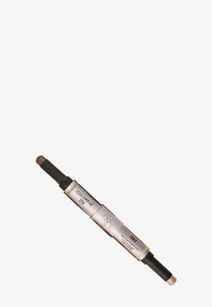 Dubbelzijdige make-upstick met een donkerbruine punt en een lichtgouden punt. Heeft een zilveren en zwarte behuizing met duidelijke labeling.