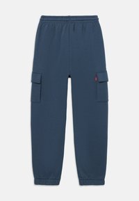 Sweatpants azuis feitos de um tecido suave, com uma cinta elástica na cintura e dois bolsos laterais para armazenamento adicional.