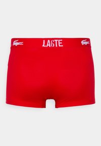 Boxer-briefs rouges au design ajusté. Dotés d'une bande logo blanche à la taille et d'un tissu lisse et extensible pour le confort.