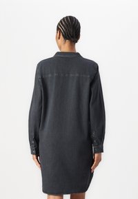Denim shirt dress in dark grey with a collar, long sleeves, and button cuffs; features a straight cut and back yoke detail.