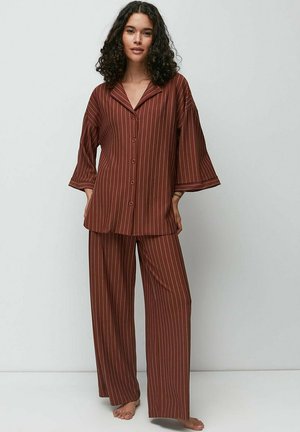 Brown striped pajama set featuring a button-up top with a collar and wide sleeves, paired with loose-fitting, striped pants. Soft fabric texture.