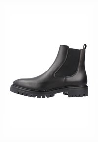 Bota Chelsea de cuero negro con paneles laterales elásticos, un ligero tacón y una suela de goma resistente con profundos surcos para tracción.